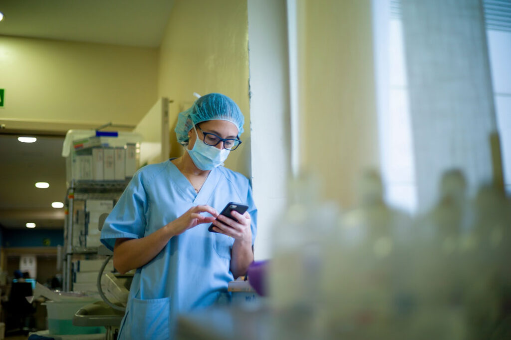 nurse checking her mobile device